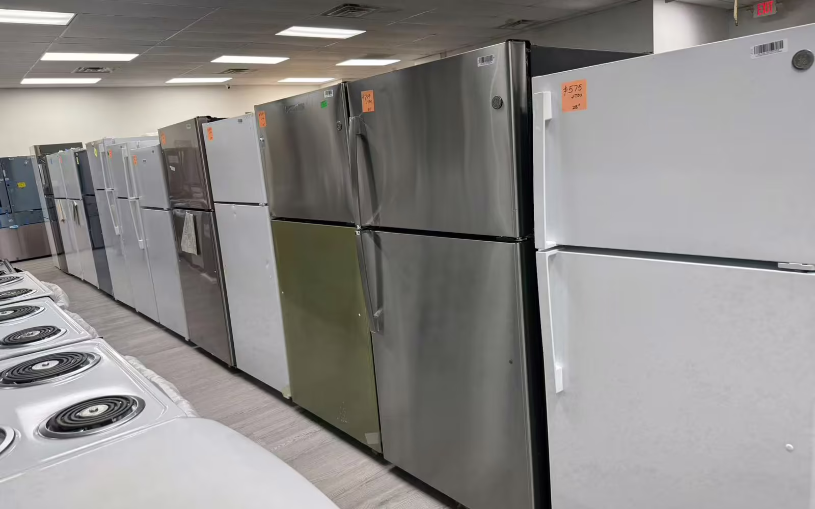 A row of refrigerators on the showroom floor