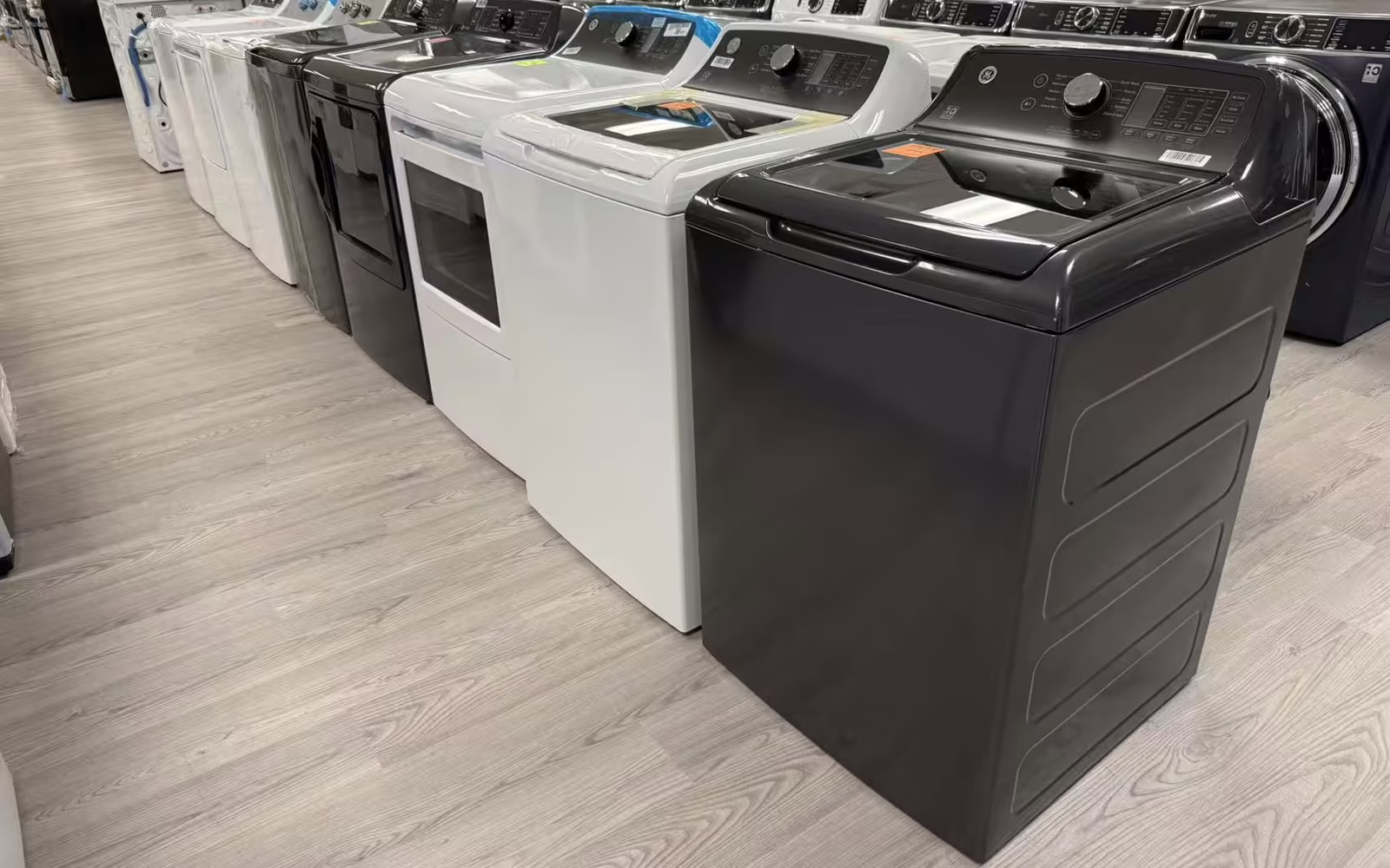 Top-load washers lined up on the Belleville showroom floor